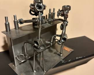 Metal sculpture, bar, nuts/bolts