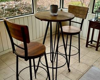 industrial-style bar table and stool set featuring a round wooden top and hairpin metal legs