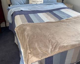 Nice bed with pretty blue sheets and comforter