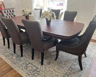 Rectangular dining table with upholstered chairs