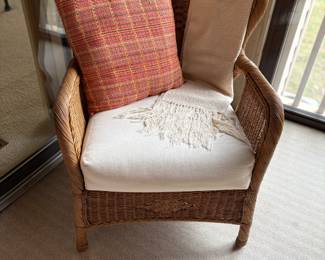 Wicker furniture with decorative pillow and throw