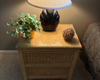 Wicker side table, table lamp and faux floral accent piece
