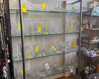 Glass shelving unit with metal standing shelf holders. $500 + tax.