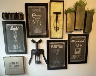 Collection of bar-themed wall decor featuring cocktail recipes and related art.