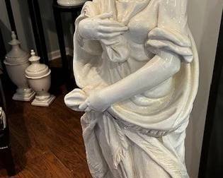 Life-sized ceramic woman figure.