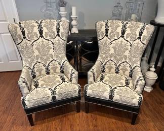Bassett Wingback chairs with nail head accents and damask fabric pattern.