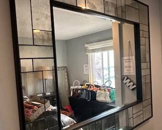 Large CB2 Perspective wall mirror with a matte black steel frame.