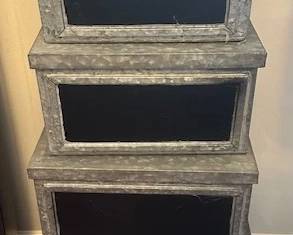 Galvanized metal storage boxes with chalkboard labels.