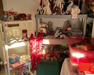 Variety of different Santa Claus’s ornaments and statues, holiday tablecloth, wreath bag, and so many bins of all types of holiday excitement.