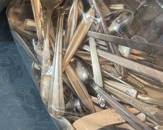 Several sets of silverware, and random pieces.