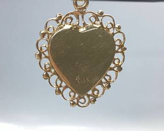 14K HEART PENDANT WITH DIAMOND AND RUBY THIS 14K HEART PENDANT FEATURES A TREBLE CLEF NOTE WITH DIAMOND AND RUBY ACCENT. WEIGHT IS 3.82 GRAMS