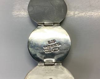 STERLING SILVER BALL LOCKET WITH 30 INCH CHAIN MEXICO STERLING SILVER BALL LOCKET OPENS 5 INCHES TO EXPOSE 6 SPACES. IT IS HUNG BY A 30 INCH BRAIDED HERRINGBONE NECKLACE