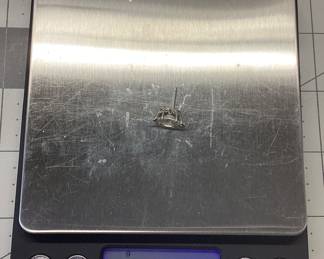 SINGLE 14K WHITE GOLD MARQUISE DIAMOND EARRING 14K WHITE GOLD SETTING FEATURING A MARQUISE SOLITAIRE DIAMOND. DIAMOND IS APPROX. 1CT WITH COLOR IS O-P, CLARITY IS I2. TOTAL WEIGHT IS 0.9 GRAMS. CARAT WEIGHT AND GRADE ARE APPROXIMATE.