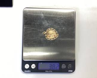 14K HEART PENDANT WITH DIAMOND AND RUBY THIS 14K HEART PENDANT FEATURES A TREBLE CLEF NOTE WITH DIAMOND AND RUBY ACCENT. WEIGHT IS 3.82 GRAMS