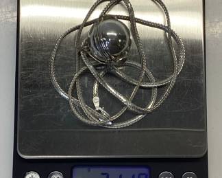 STERLING SILVER BALL LOCKET WITH 30 INCH CHAIN MEXICO STERLING SILVER BALL LOCKET OPENS 5 INCHES TO EXPOSE 6 SPACES. IT IS HUNG BY A 30 INCH BRAIDED HERRINGBONE NECKLACE