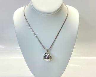 STERLING SILVER BALL LOCKET WITH 30 INCH CHAIN MEXICO STERLING SILVER BALL LOCKET OPENS 5 INCHES TO EXPOSE 6 SPACES. IT IS HUNG BY A 30 INCH BRAIDED HERRINGBONE NECKLACE