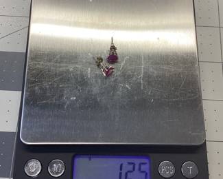 14K TRILLION CUT RUBY EARRINGS THESE 14K WHITE GOLD EARRINGS FEATURE TWO 3/4 CARAT TRILLION CUT RUBIES. WEIGHT IS 1.25 GRAMS
