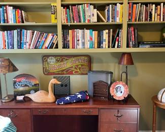 Credenza, books and large, heavy fabric flag.