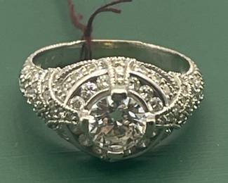 14kt white gold with approximately 2 carat of diamonds total but featuring a 1.05 carat diamond center stone.  Size 7