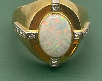 1940's 14kt yellow gold ring featuring large center opal with smaller accent diamonds.