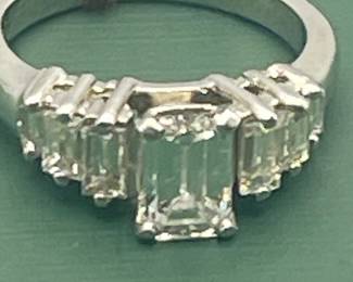 1940's / 1950's platinum ring featuring a 1.02 carat emerald cut center diamond and 0.6 carats of side diamonds.  Diamonds are estimated to be VSG.  Size 5 ½