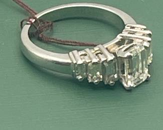 1940's / 1950's platinum ring featuring a 1.02 carat emerald cut center diamond and 0.6 carats of side diamonds.  Diamonds are estimated to be VSG.  Size 5 ½