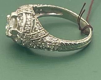 14kt white gold with approximately 2 carat of diamonds total but featuring a 1.05 carat diamond center stone. Size 7