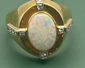 1940's 14kt yellow gold ring featuring large center opal with smaller accent diamonds.
