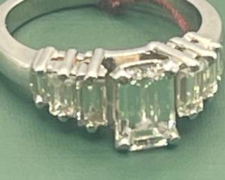 1940's / 1950's platinum ring featuring a 1.02 carat emerald cut center diamond and 0.6 carats of side diamonds. Diamonds are estimated to be VSG. Size 5 ½
