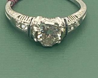 Antique Platinum diamond ring featuring an approximate 1/2 carat diamond center with accent stones. Size 6 ¼