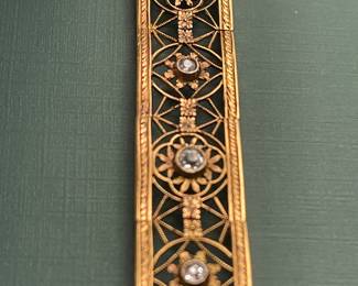 Antique 18kt yellow gold filigree bracelet featuring approximately 1.5 carats of diamonds and a box clasp adorned with a smaller diamond.