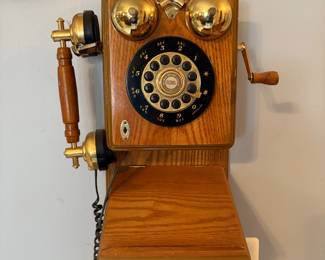 AI Overview

The image features a Thomas Collector's Edition replica wall-mounted telephone. This is a reproduction model designed to look like a vintage 1920s or 1930s country-style telephone, possibly a "Spirit of St. Louis" model. 
