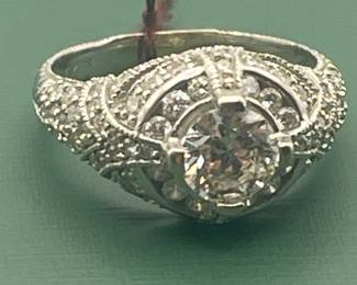 14kt white gold with approximately 2 carat of diamonds total but featuring a 1.05 carat diamond center stone.  Size 7