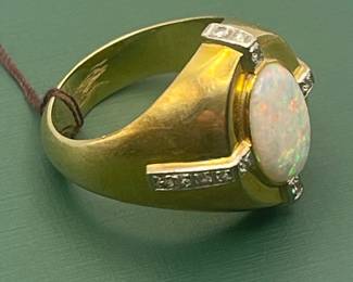 1940's 14kt yellow gold ring featuring large center opal with smaller accent diamonds.