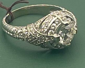 14kt white gold with approximately 2 carat of diamonds total but featuring a 1.05 carat diamond center stone.  Size 7