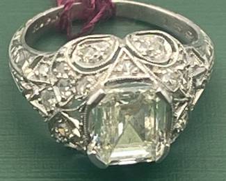 Custom designed platinum ring circa 1915 - 1920 featuring a very rare Asscher-cut, 1.05 carat center diamond and accented with approximately 0.25 carats of smaller accent diamonds.  Size 3 1/2