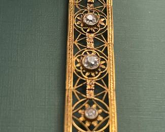 Antique 18kt yellow gold filigree bracelet featuring approximately 1.5 carats of diamonds and a box clasp adorned with a smaller diamond.