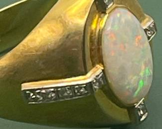 1940's 14kt yellow gold ring featuring large center opal with smaller accent diamonds.