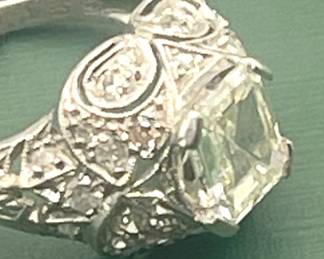 Custom designed platinum ring circa 1915 - 1920 featuring a very rare Asscher-cut, 1.05 carat center diamond and accented with approximately 0.25 carats of smaller accent diamonds.  Size 3 1/2