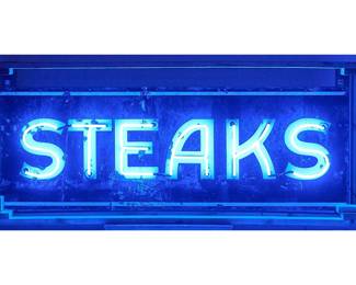 Large vintage single-sided metal smokehouse sign that reads "STEAKS" with modern in blue tubing, circa 20th century, includes wooden shipping frame