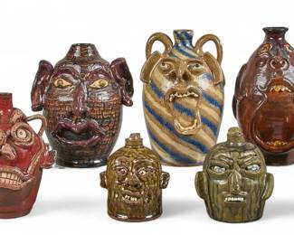 Collection of six stoneware face jugs, some signed underneath