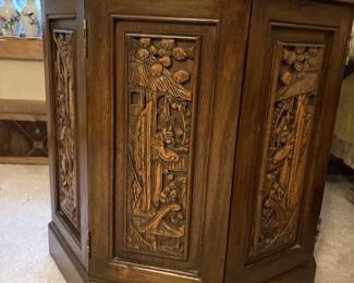 This is an elaborately carved octagonal Asian inspired end table.  Very unique.