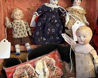 A pair of small china dolls.  The one on the right is early 1800's.   Note the bisque doll on the right has an ABC body...super cute!