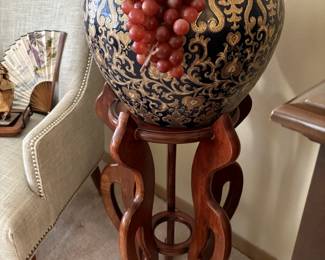 Large decorative fish bowl on stand.