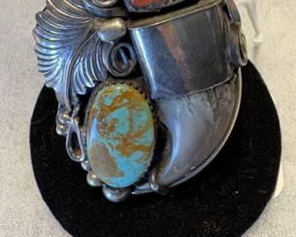 The picture doesn't do this ring justice.  This is a large men's bear claw ring with coral and turquoise.  A great piece!