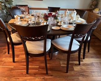 Very nice round dining table seats eight.  Nice clean cushioned chairs.  This set would go with any style.