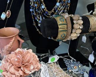 Jewelry items and Beswick bird figurine.