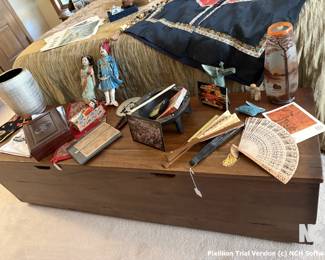 This is a picture of a rather unusual long storage chest. It would go with any decor and fits exactly at the foot of the bed.
