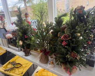 Lots of Christmas decor; Christmas trees; garlands; christmas dishes; lights