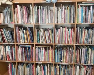 homemade dolls; porcelain dolls, stuffed animals, children's books, large bookshelf